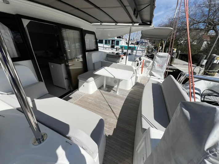 Sia Yacht Photos Pics Spacious deck of 2022 Excess XCS 11 yacht with seating and table.