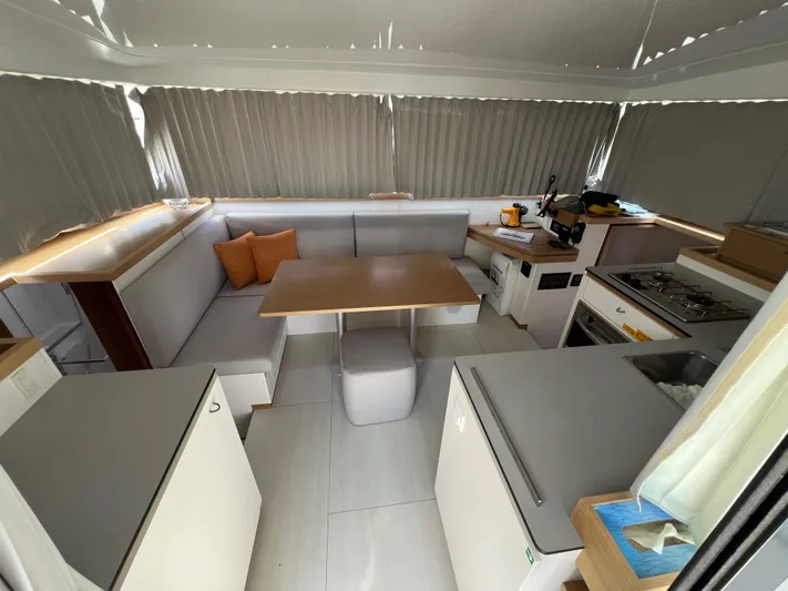 Sia Yacht Photos Pics Modern interior of 2022 Excess XCS 11 catamaran with kitchen and dining area.