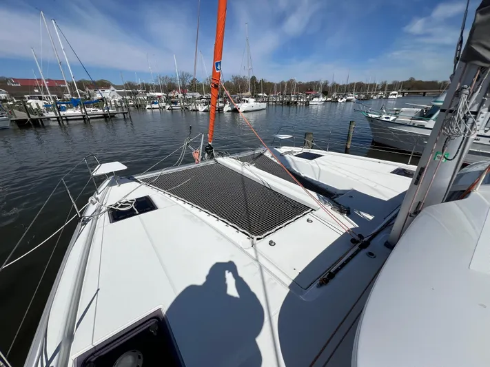 Sia Yacht Photos Pics 2022 Excess XCS 11 catamaran docked at marina under blue sky.