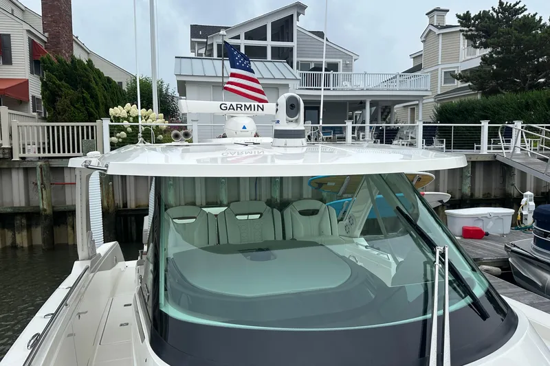  Yacht Photos Pics 2022 Tiara Yachts 38 LS docked, featuring Garmin equipment and American flag.