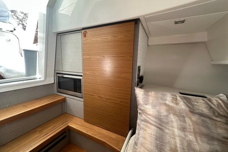 Yacht Photos Pics Interior of 2022 Tiara Yachts 38 LS, featuring wood accents and a built-in microwave.