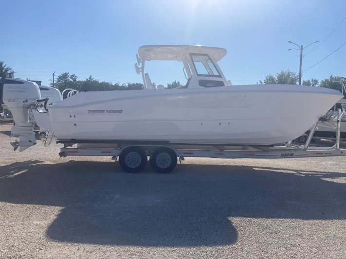  Yacht Photos Pics 2025 Twin Vee 280GFX2 boat on trailer, side view in sunlight.
