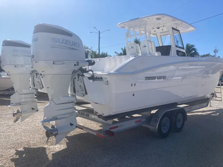  Yacht Photos Pics 2025 Twin Vee 280GFX2 boat with dual Suzuki outboard motors on a trailer.