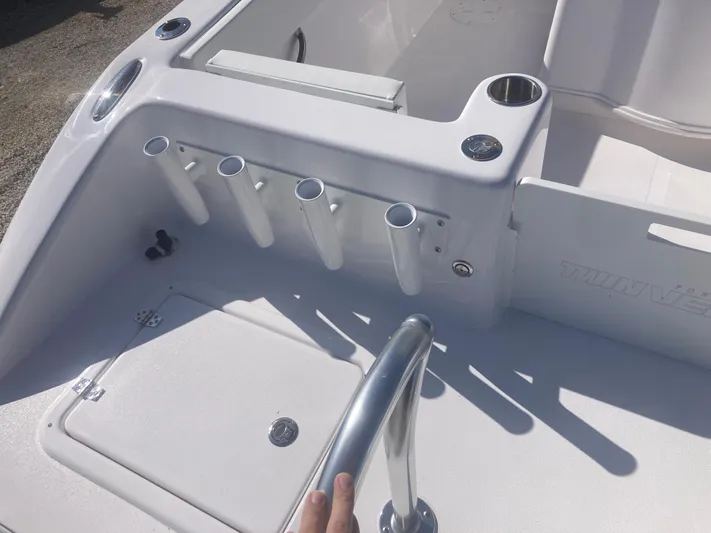  Yacht Photos Pics 2025 Twin Vee 280GFX2 boat deck with rod holders and storage compartment.