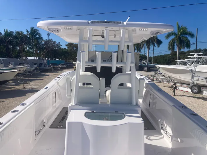  Yacht Photos Pics 2025 Twin Vee 280GFX2 boat interior with seating and helm, parked outdoors.