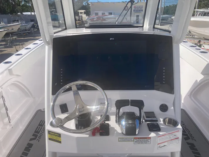  Yacht Photos Pics 2025 Twin Vee 280GFX2 boat dashboard with steering wheel and controls.