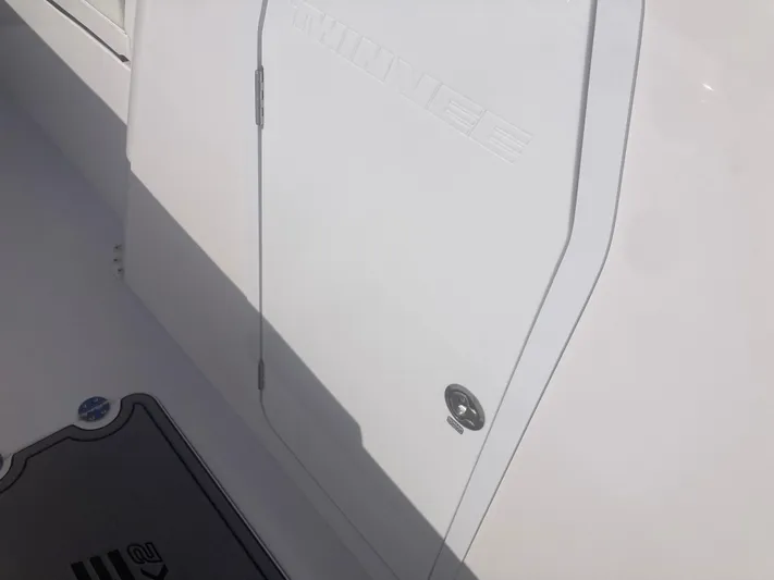  Yacht Photos Pics 2025 Twin Vee 280GFX2 boat deck with storage compartment and mat.