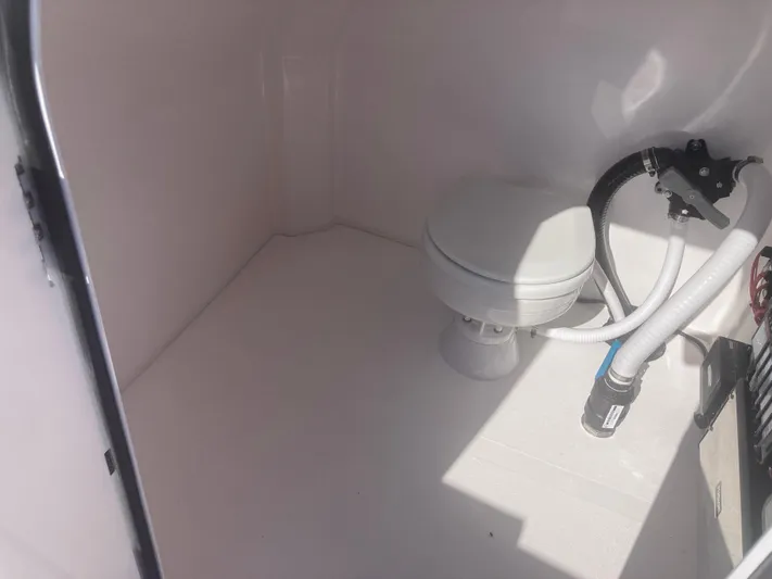  Yacht Photos Pics Interior of 2025 Twin Vee 280GFX2 boat with compact marine toilet.