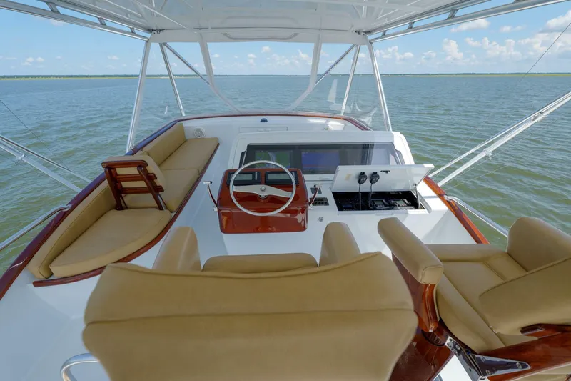 Salemwolf Yacht Photos Pics Helm of 2000 Garlington 61 C yacht with tan seating and ocean view.