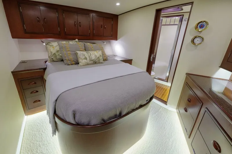 Salemwolf Yacht Photos Pics Luxurious bedroom interior in a 2000 Garlington 61 C yacht, featuring elegant wood cabinetry.