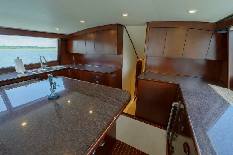 Salemwolf Yacht Photos Pics Luxurious kitchen interior of 2000 Garlington 61 C yacht with wooden cabinetry and ocean view.