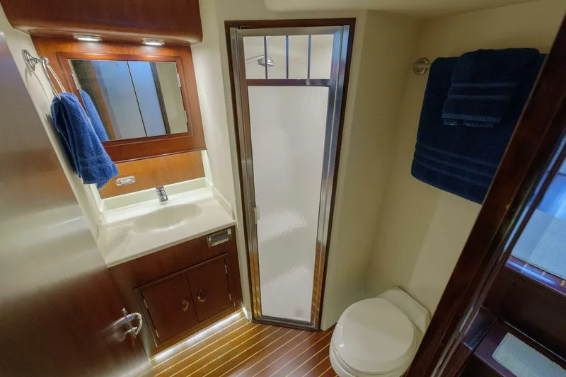 Salemwolf Yacht Photos Pics Luxurious bathroom in 2000 Garlington 61 C yacht with shower, sink, and toilet.