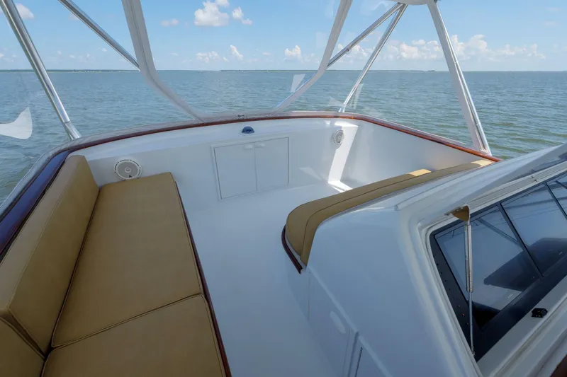 Salemwolf Yacht Photos Pics Luxurious Garlington 61 C yacht interior with tan seating, overlooking serene ocean waters.