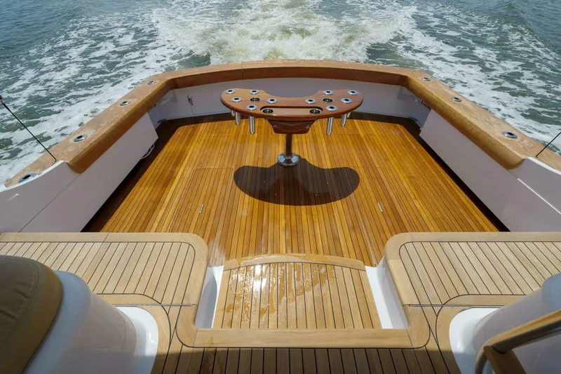 Salemwolf Yacht Photos Pics Luxurious Garlington 61 C yacht deck with wooden finish, 2000 model, cruising on water.