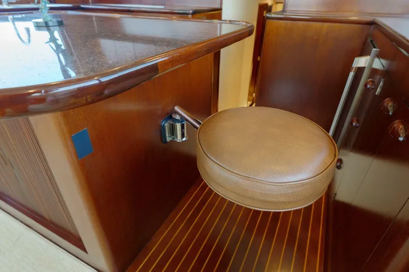 Salemwolf Yacht Photos Pics Luxurious wooden interior of a 2000 Garlington 61 C yacht with a leather stool.