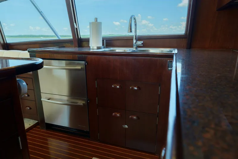 Salemwolf Yacht Photos Pics Luxurious yacht kitchen interior with wooden cabinetry and stainless steel appliances, Garlington 61 C, 2000.