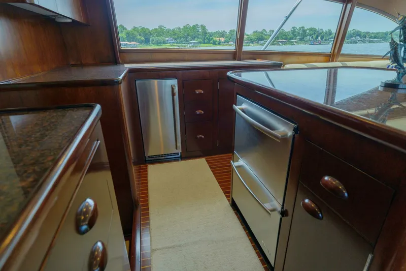 Salemwolf Yacht Photos Pics Luxurious kitchen interior of 2000 Garlington 61 C yacht with wood cabinetry and stainless appliances.