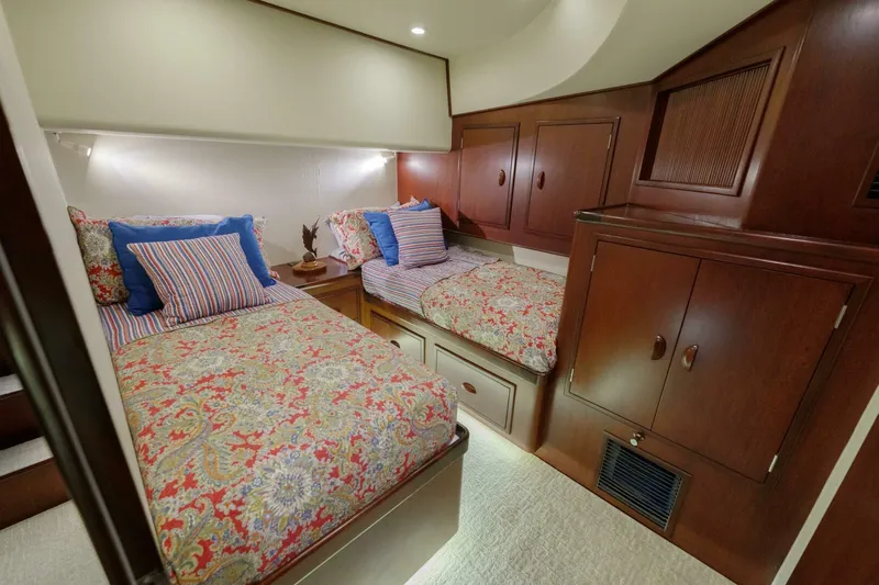 Salemwolf Yacht Photos Pics Luxurious cabin interior of 2000 Garlington 61 C yacht with twin beds and wooden cabinetry.
