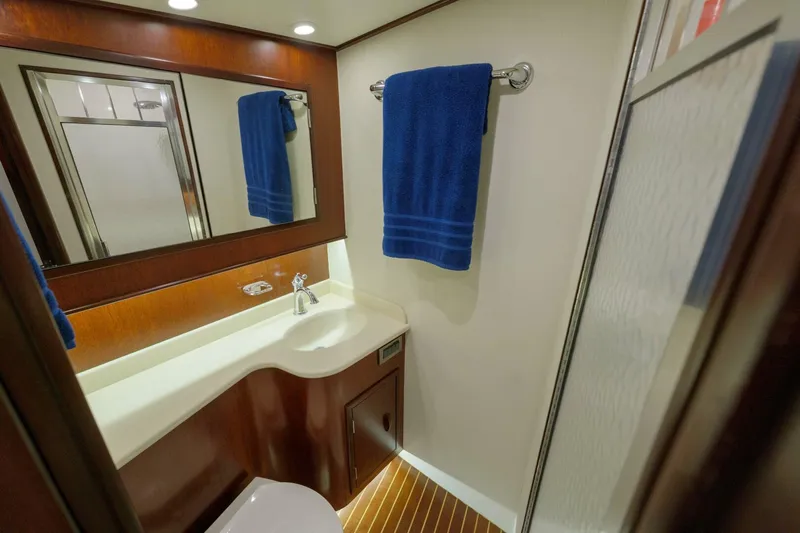 Salemwolf Yacht Photos Pics Luxurious bathroom in 2000 Garlington 61 C yacht with blue towel and modern fixtures.