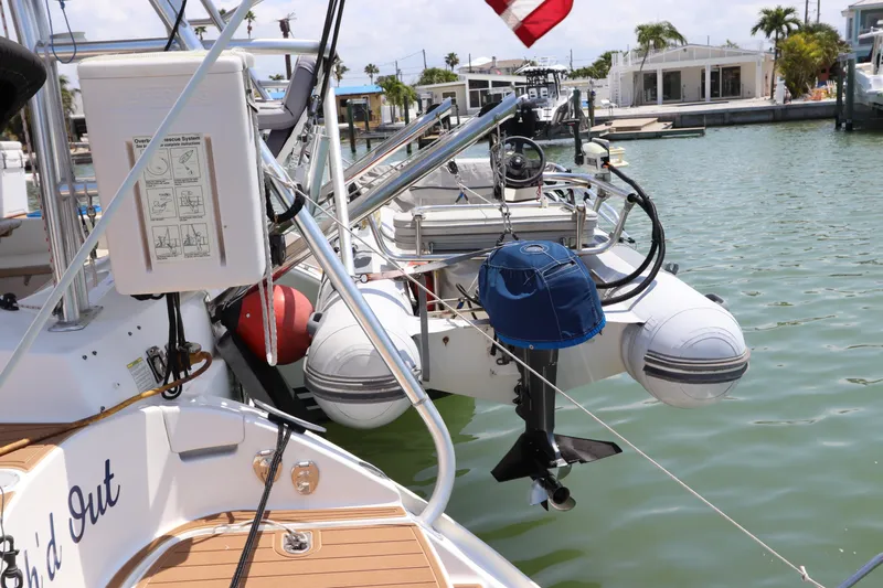  Yacht Photos Pics Lagoon 380 catamaran, 2001 model, docked with dinghy and equipment, sunny marina setting.