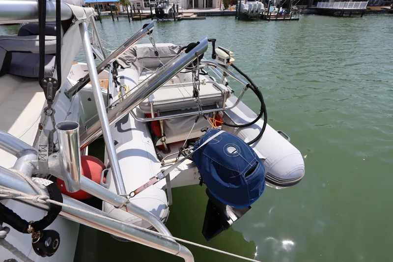  Yacht Photos Pics Inflatable dinghy attached to Lagoon 380 catamaran, 2001 model, docked in marina.