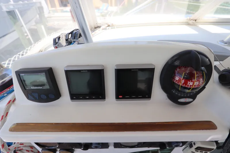  Yacht Photos Pics Control panel of a 2001 Lagoon 380 catamaran with navigation instruments and compass.