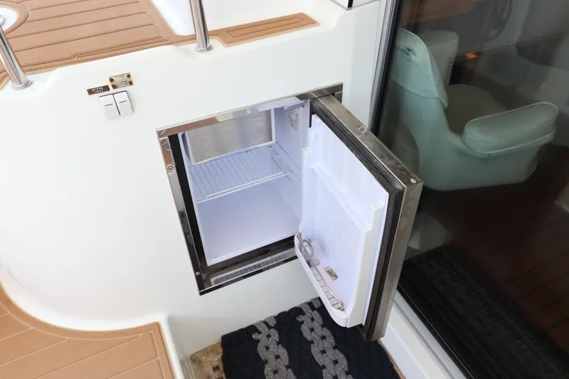  Yacht Photos Pics Open mini fridge on Lagoon 380 yacht, 2001 model, with wooden deck and glass door.