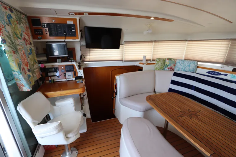  Yacht Photos Pics Interior of 2001 Lagoon 380 catamaran with seating, table, and navigation equipment.