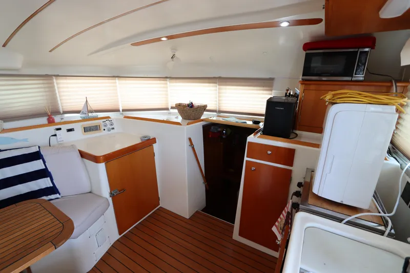  Yacht Photos Pics Interior of 2001 Lagoon 380 catamaran with wood accents and modern amenities.
