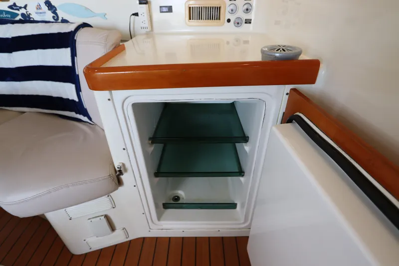  Yacht Photos Pics Interior of 2001 Lagoon 380 yacht with open mini fridge and seating area.