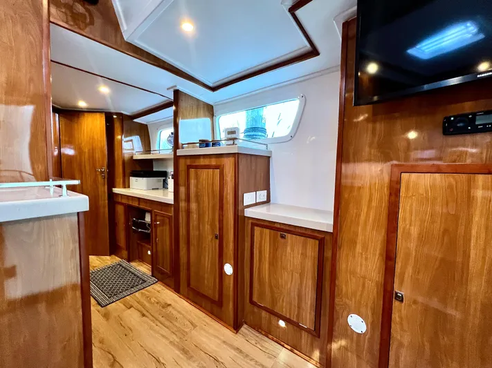 Walkabout Yacht Photos Pics Luxurious 2019 Royal Cape Catamarans 530 interior with wood finish and modern amenities.