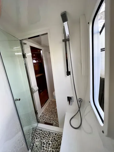 Walkabout Yacht Photos Pics Modern bathroom in 2019 Royal Cape Catamarans 530 with pebble flooring and glass shower.