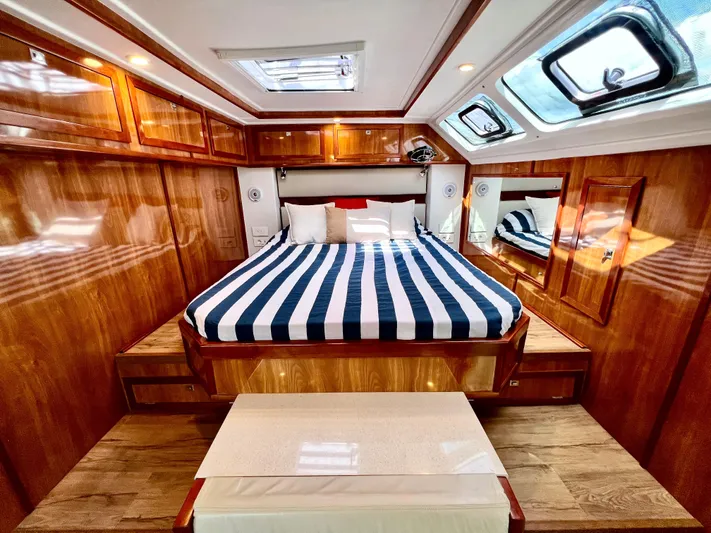 Walkabout Yacht Photos Pics Luxurious cabin interior of 2019 Royal Cape Catamarans 530 with striped bedding.