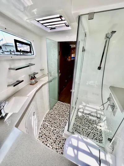Walkabout Yacht Photos Pics Luxurious 2019 Royal Cape Catamarans 530 bathroom with modern shower and sleek design.