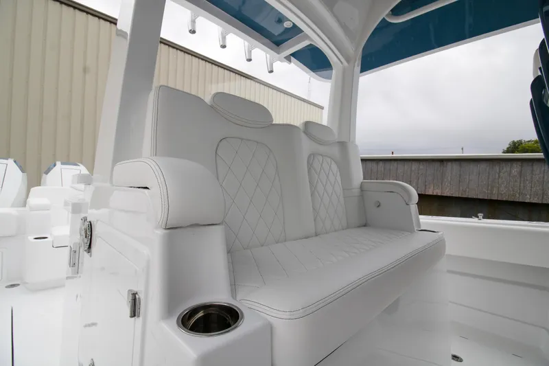  Yacht Photos Pics 2025 HCB 42 Lujo boat interior with white cushioned seating and cup holder.