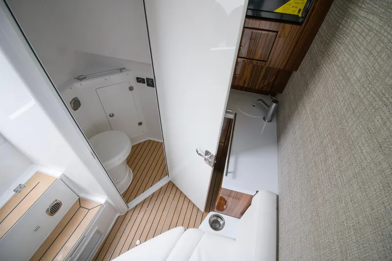  Yacht Photos Pics Interior of 2025 HCB 42 Lujo boat, featuring a compact bathroom with wooden accents.