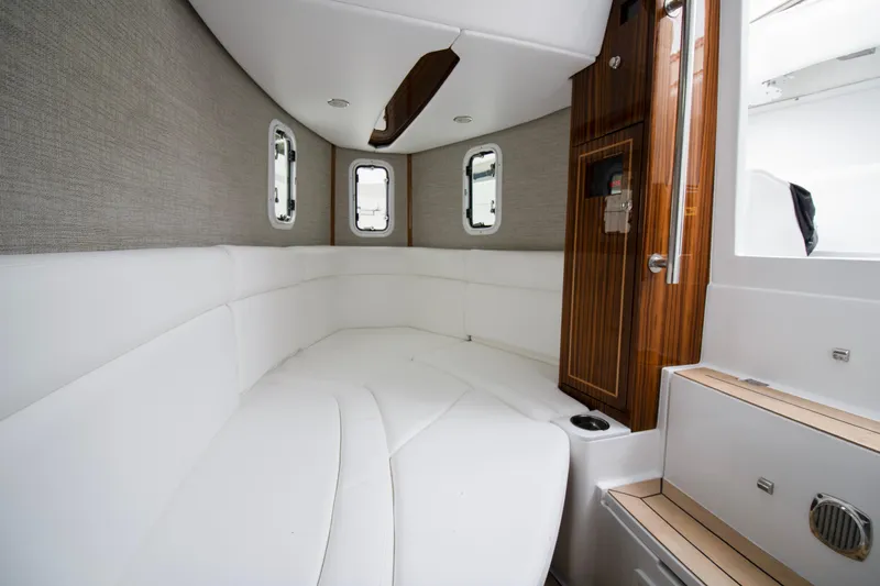  Yacht Photos Pics Luxurious interior of 2025 HCB 42 Lujo boat with white seating and wood accents.