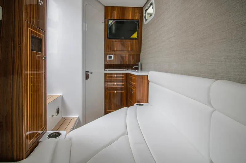  Yacht Photos Pics Interior of 2025 HCB 42 Lujo boat with white seating and wooden cabinetry.