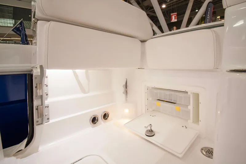  Yacht Photos Pics Interior view of 2025 HCB 42 Lujo boat, featuring sleek white seating and storage compartment.