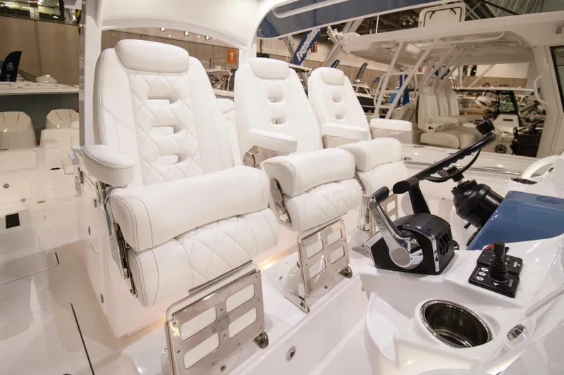  Yacht Photos Pics Luxury seating on 2025 HCB 42 Lujo boat, featuring white leather and modern controls.