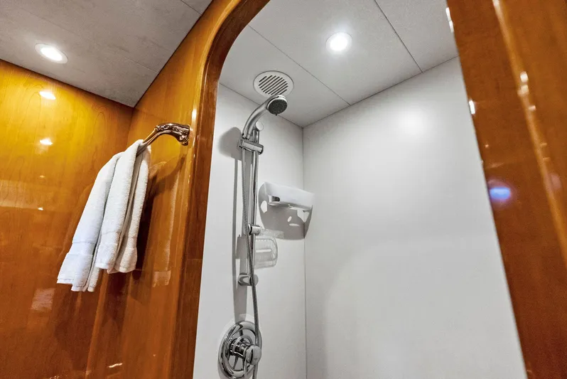 Tortuga Yacht Photos Pics Luxurious shower area in 1999 Monte Fino 82 yacht with wooden accents and modern fixtures.