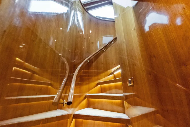 Tortuga Yacht Photos Pics Luxurious wooden staircase on 1999 Monte Fino 82 yacht with elegant lighting.