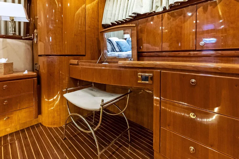 Tortuga Yacht Photos Pics Luxurious wooden interior of 1999 Monte Fino 82 yacht with vanity and seating.