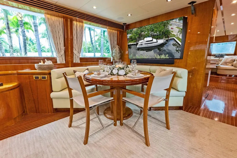 Tortuga Yacht Photos Pics Luxurious dining area on 1999 Monte Fino 82 yacht with elegant decor and large windows.