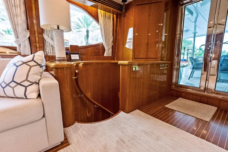 Tortuga Yacht Photos Pics Luxurious interior of 1999 Monte Fino 82 yacht with elegant wood finishes and cozy seating.