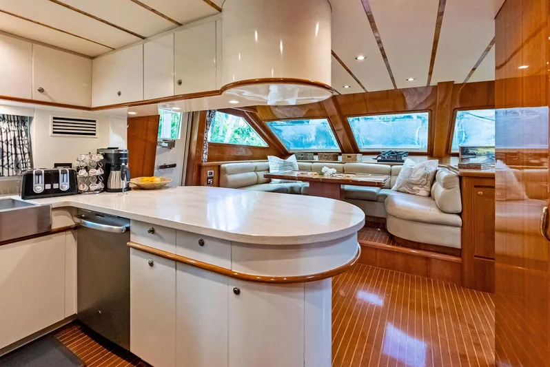 Tortuga Yacht Photos Pics Luxurious interior of 1999 Monte Fino 82 yacht with modern kitchen and spacious seating area.