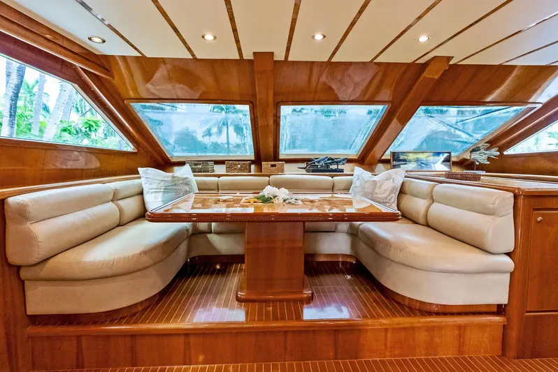 Tortuga Yacht Photos Pics Luxurious interior of 1999 Monte Fino 82 yacht with elegant seating and wooden finishes.