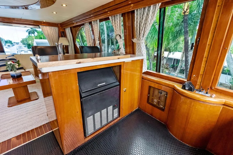 Tortuga Yacht Photos Pics Luxurious interior of 1999 Monte Fino 82 yacht with wood paneling and large windows.