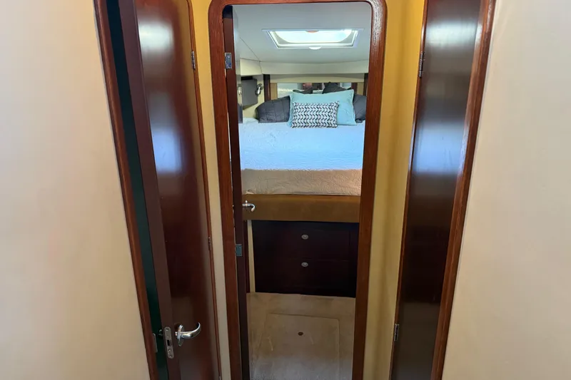  Yacht Photos Pics 2006 Sea Ray 44 Sedan Bridge cabin interior with bed and wooden door.