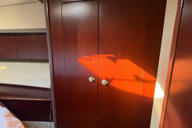  Yacht Photos Pics Wooden cabinet in 2006 Sea Ray 44 Sedan Bridge interior, illuminated by sunlight.